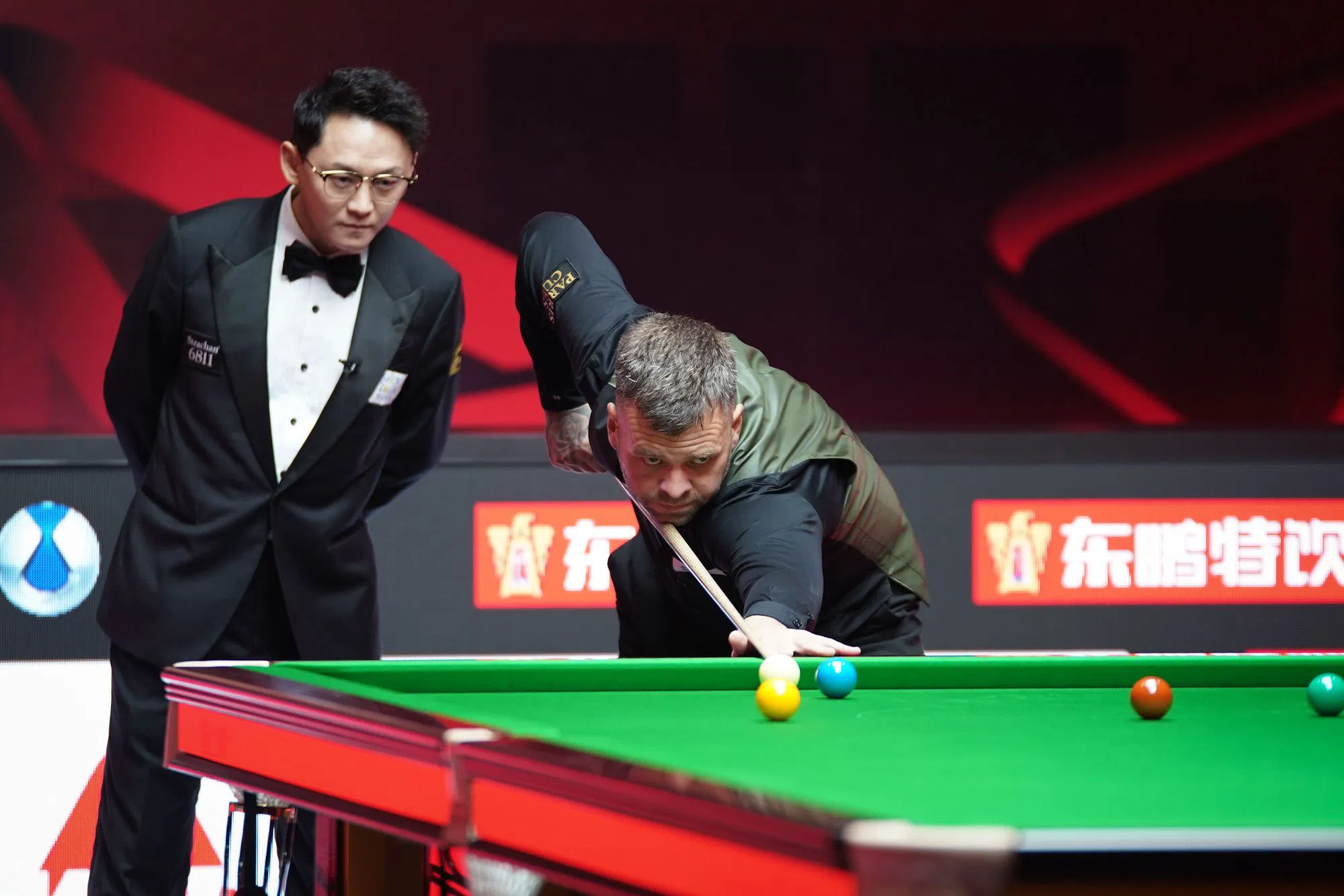 Chris Wakelin plays a shot against Jimmy Robertson